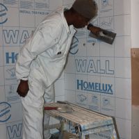 Fixing water proofing membrane to walls in shower area