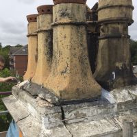 Damaged chimney pots and large crack in chimney