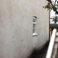 Plain face finish Lime rendered house wall