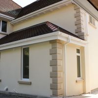 Exterior render corner stones home and garage